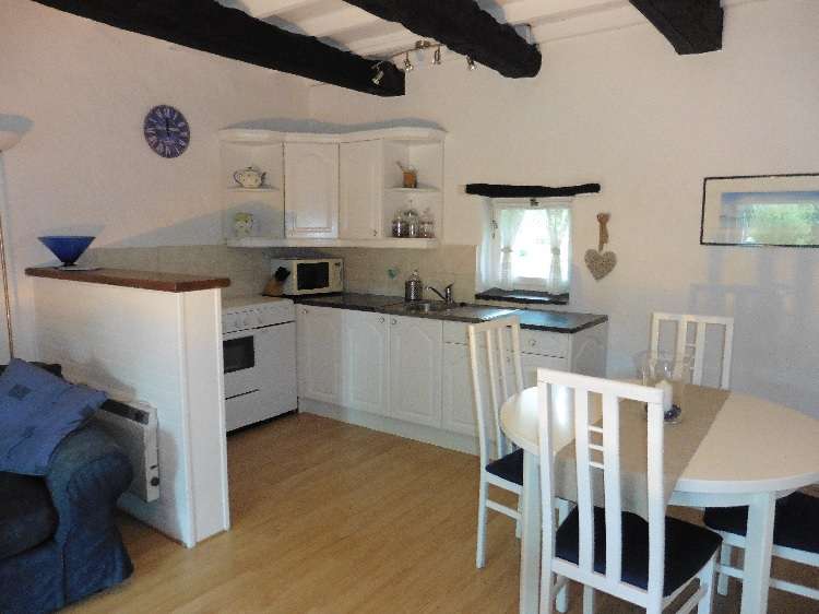 White kitchen and dining area in the Old Granary gite
